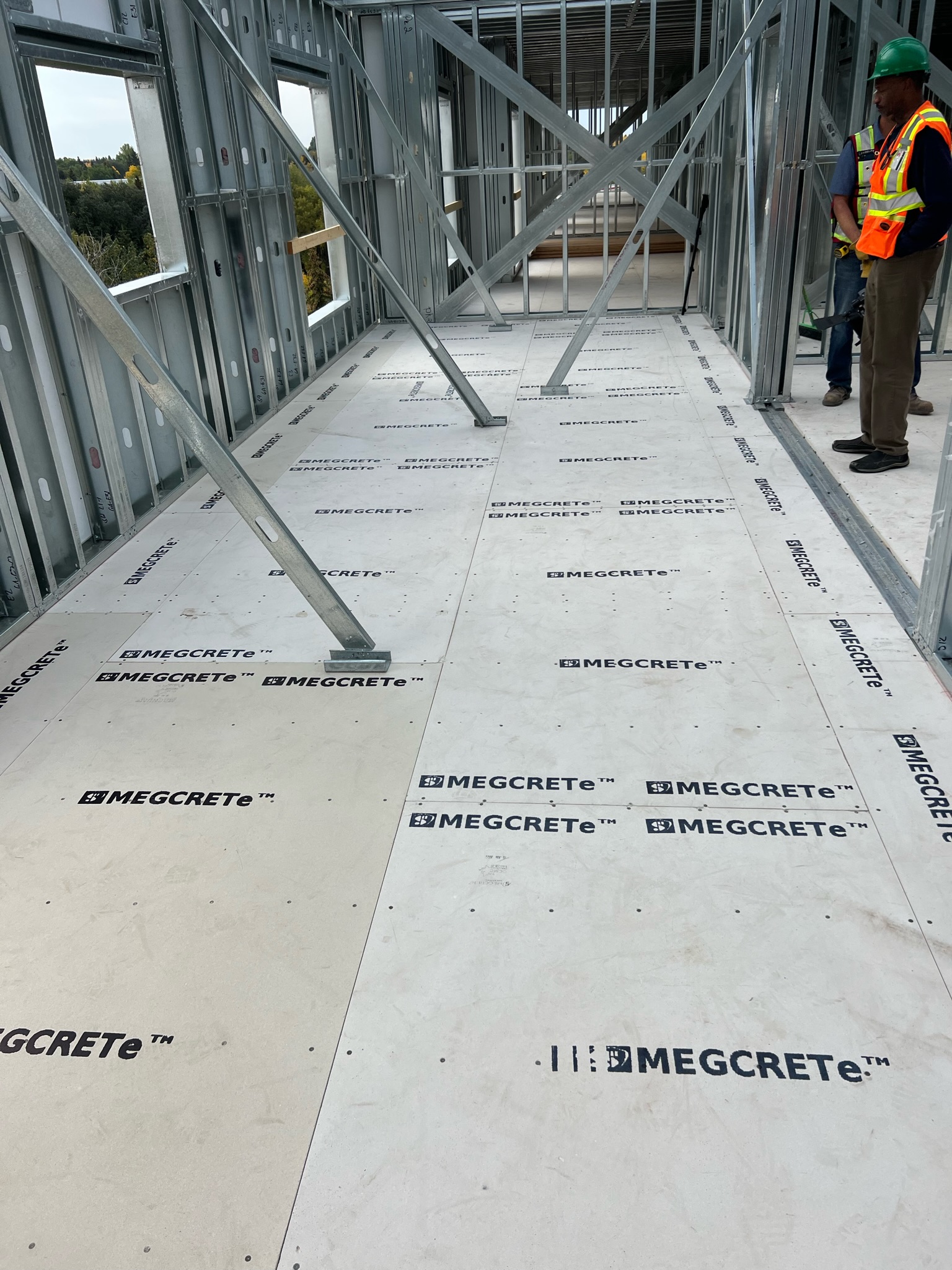 MEGCRETe floor sheathing installed across steel joists in a multi-storey steel-framed build